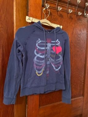 dELiA*s Navy Pullover Hoodie with Ribcage Graphic and Pink Heart Patch